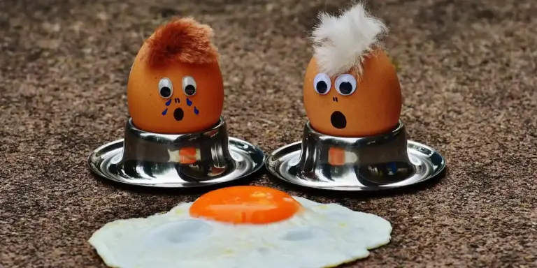 Two brown eggs with googly eyes sit in metal egg cups on a brown speckled countertop, with a fried sunny-side-up egg laid out in front, creating a playful scene that illustrates the article about geckos and eggs.