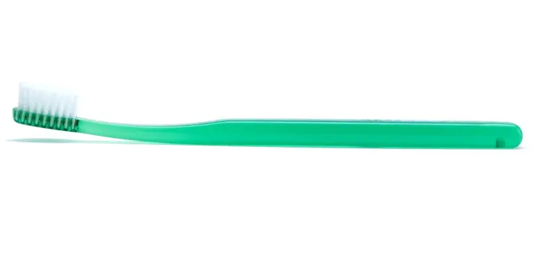 Green toothbrush with white bristles on a white background